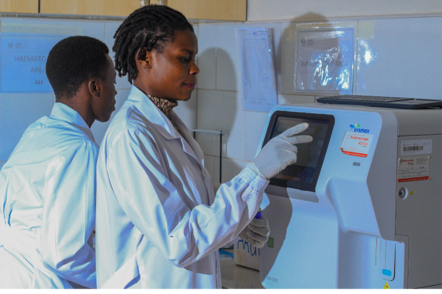 Laboratory staff operating a haematology analyser